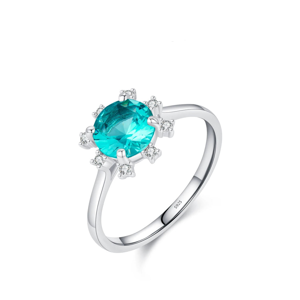 Silver ring with a blue gemstone and 'hat-hor' branding on a white backgrond