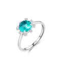 Silver ring with a blue gemstone and 'hat-hor' branding on a white backgrond
