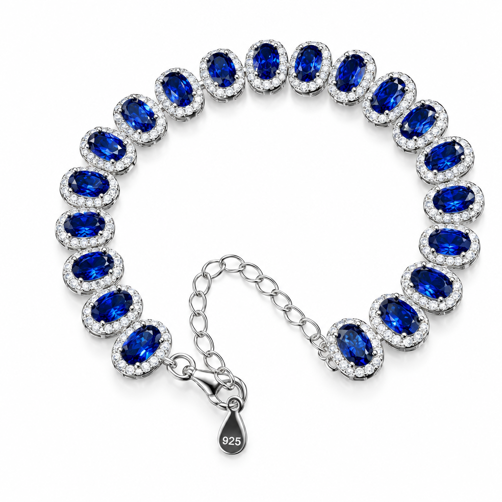 A silver 925 bracelet with oval deep blue gemstones, each surrounded by small clear stones